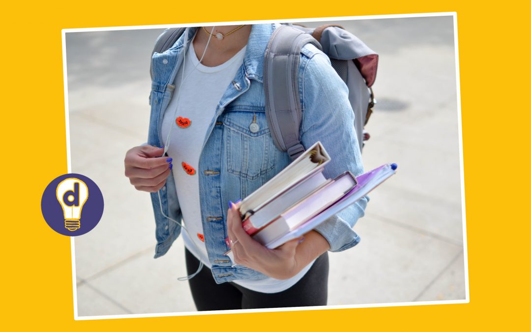 A student carrying folders